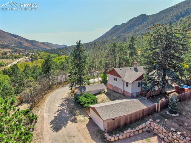 9915 Mesa Road Cascade, CO 80809 - Photo 3 of 25 Captures the beautiful view up and down Ute Pass and shows the main 2 car garage and the 1 car that could be great storage for all your toys