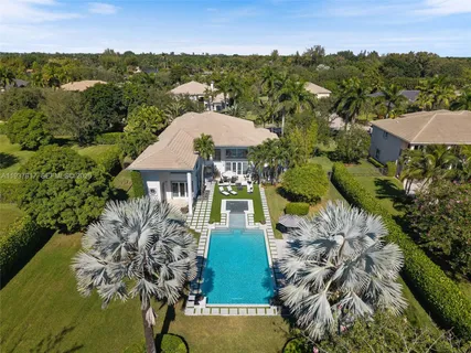 a kitchen with kitchen island granite countertop a sink counter top space appliances and cabinets