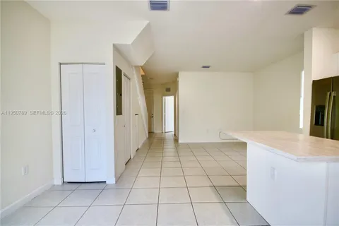 a view of a kitchen with white cabinets