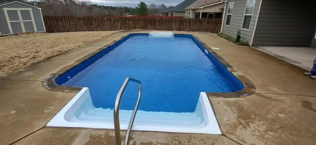 a view of a house with wooden fence