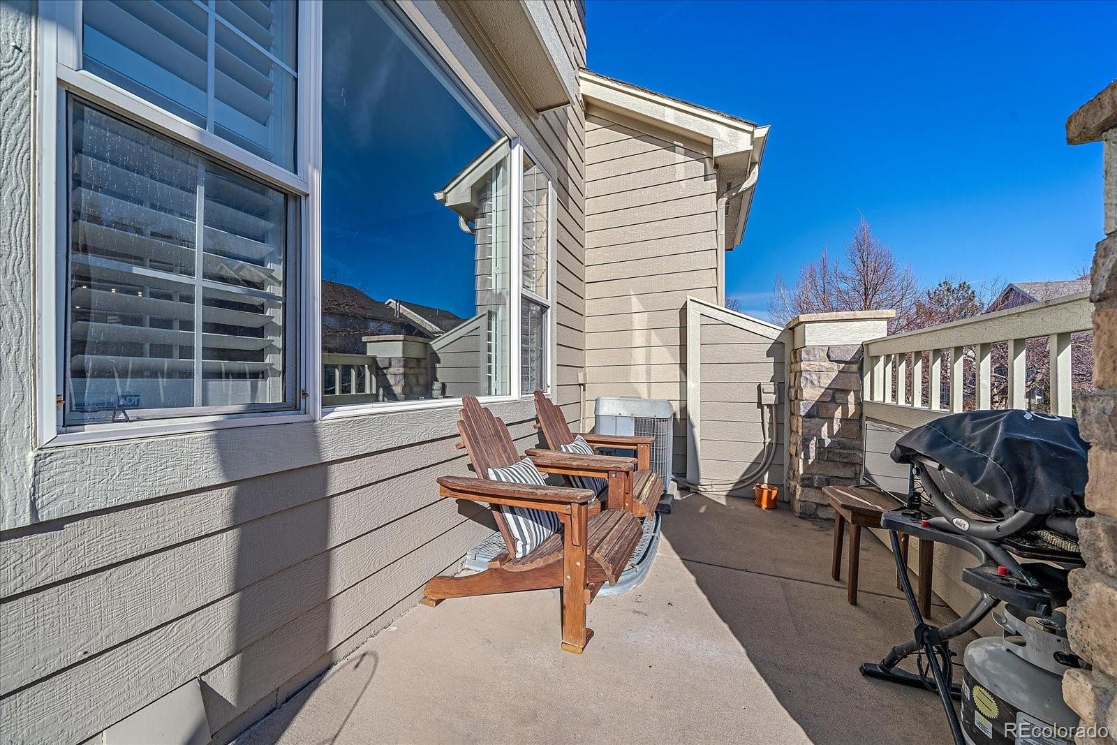 6318 Trailhead Road Highlands Ranch, CO 80130 - Photo 3 of 32 a view of a patio with a table and chairs
