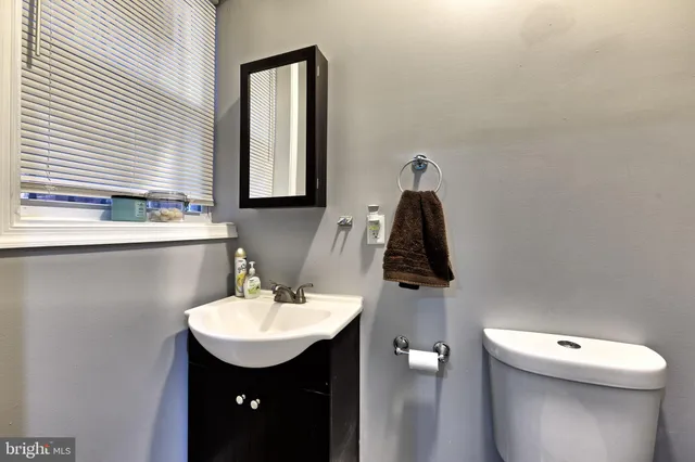a bathroom with a toilet sink and mirror