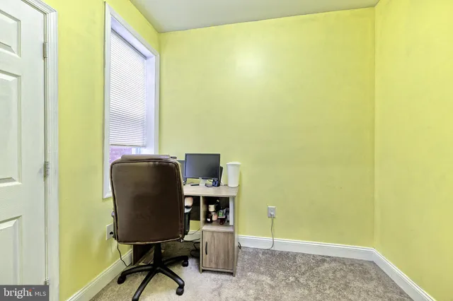 a view of a workspace with furniture and a gate