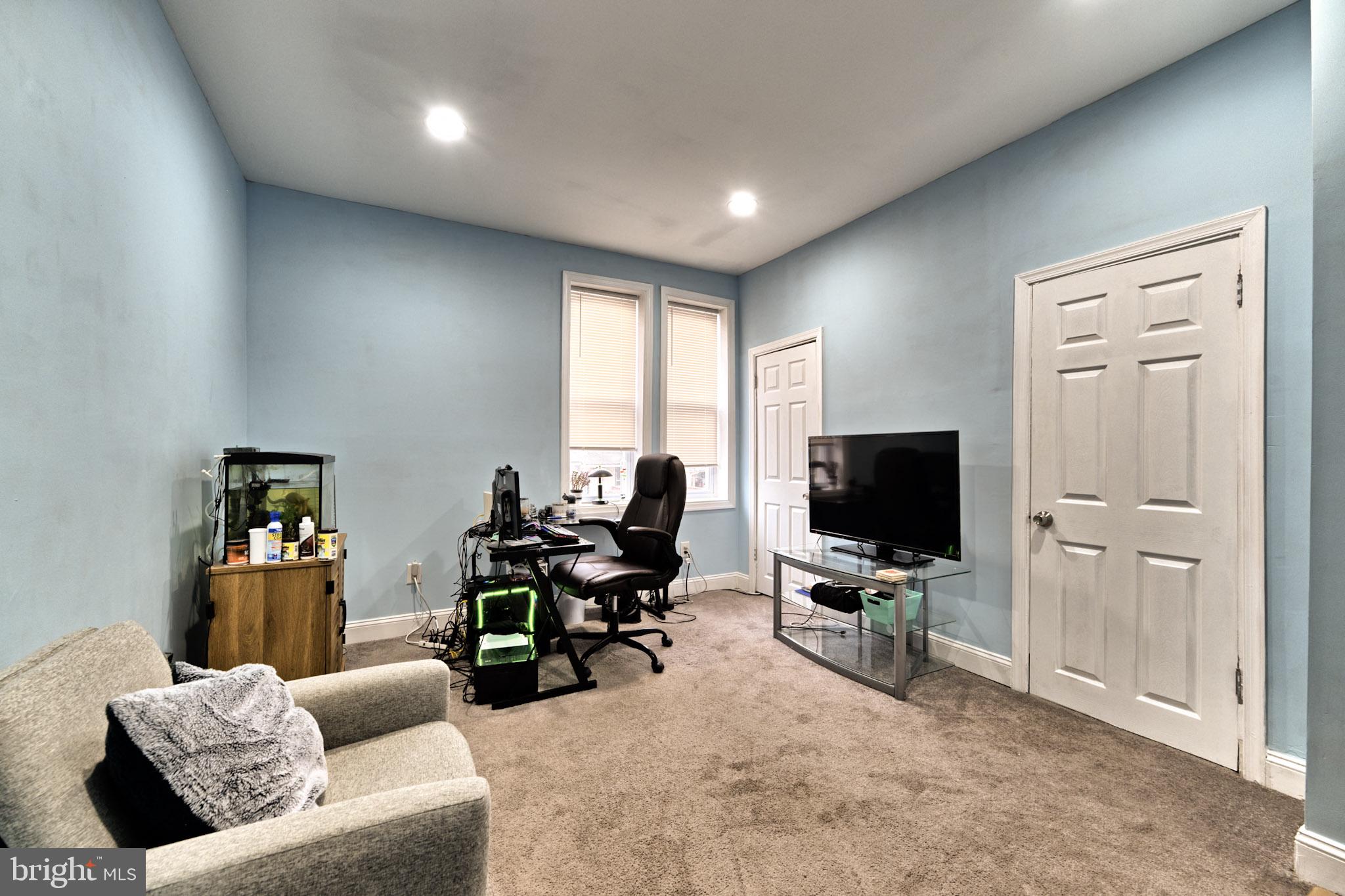 318 East 28th Street Baltimore, MD 21218 - Photo 13 of 20 a living room with furniture and a flat screen tv