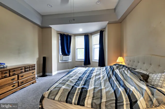 a bedroom with a bed and a dresser