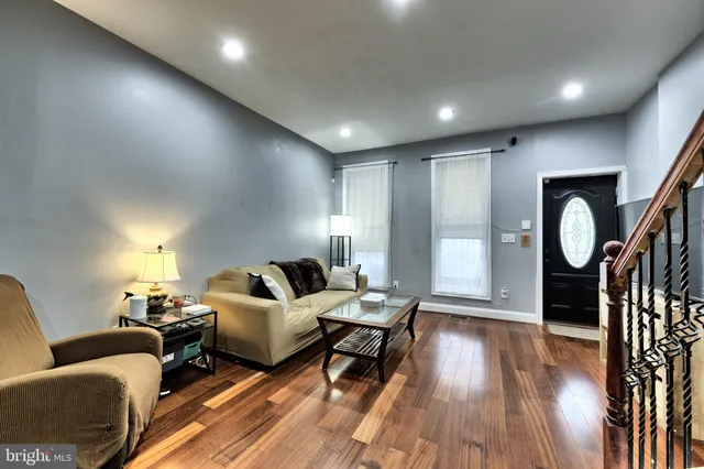 a living room with furniture and wooden floor