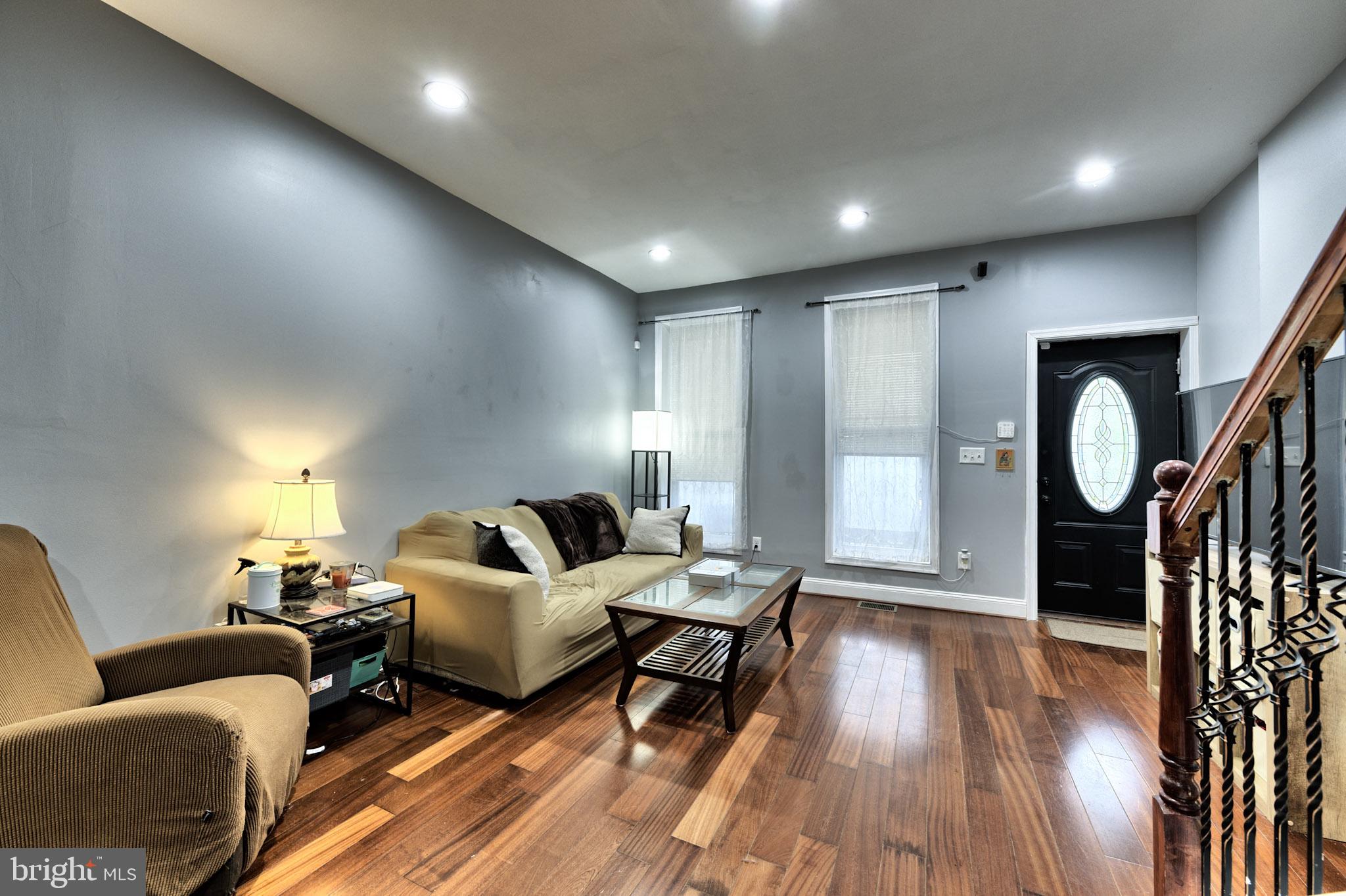 318 East 28th Street Baltimore, MD 21218 - Photo 3 of 20 a living room with furniture and wooden floor