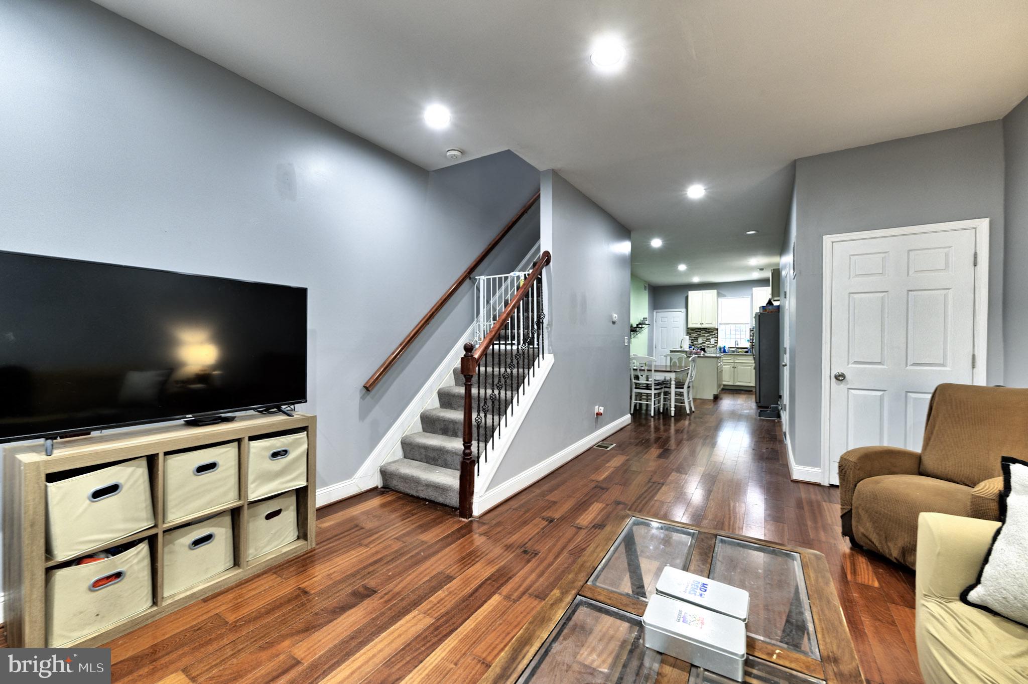 318 East 28th Street Baltimore, MD 21218 - Photo 4 of 20 a living room with furniture and a flat screen tv
