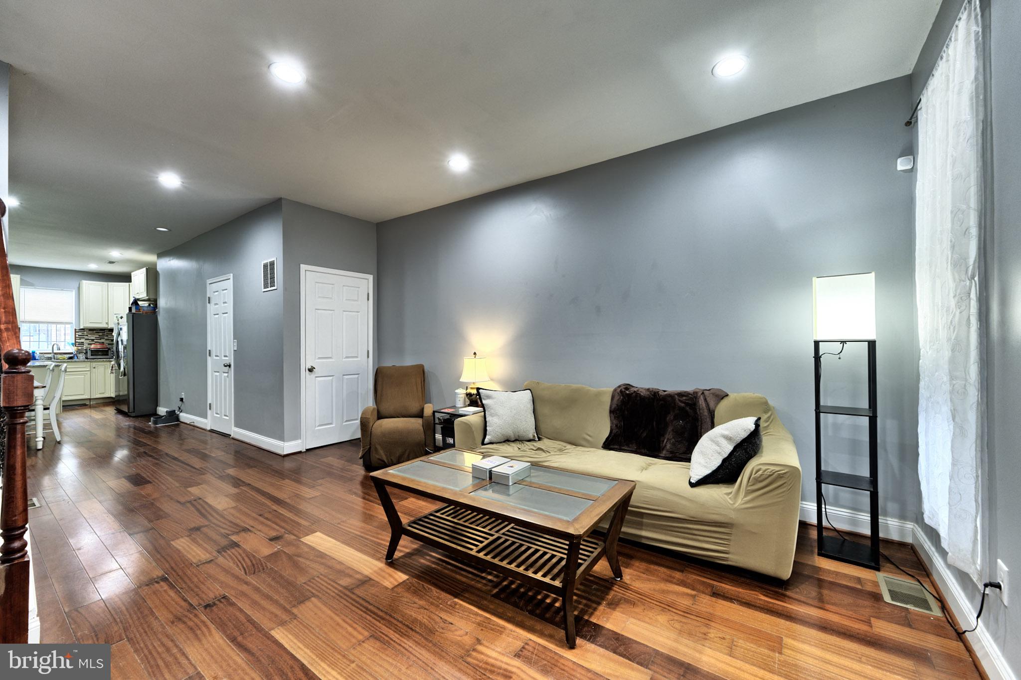 318 East 28th Street Baltimore, MD 21218 - Photo 5 of 20 a living room with furniture and a wooden floor