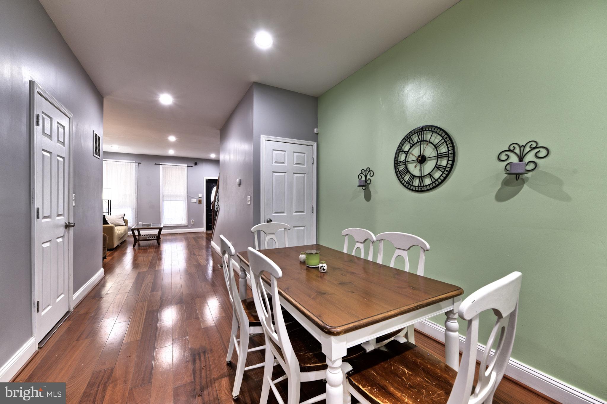 318 East 28th Street Baltimore, MD 21218 - Photo 9 of 20 a view of a dining area with furniture and a clock