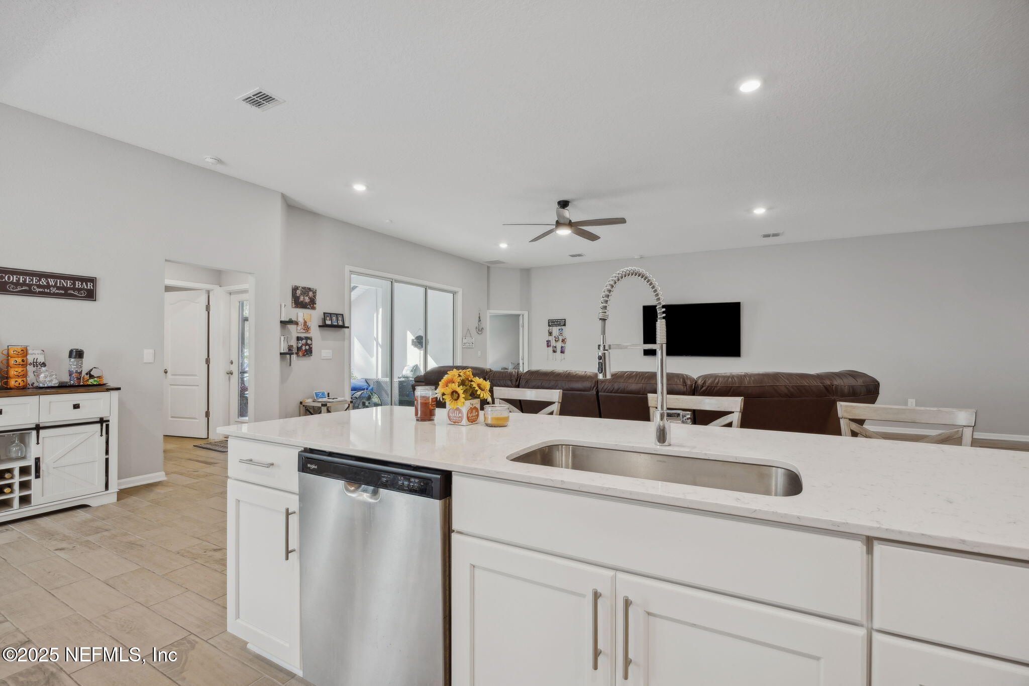 34 Riva Ridge Court Jacksonville, FL 32218 - Photo 11 of 34 a room with a sink a couch and a flat screen tv