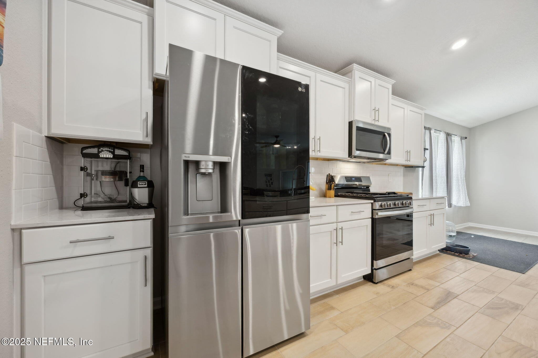 34 Riva Ridge Court Jacksonville, FL 32218 - Photo 13 of 34 a kitchen with white cabinets and stainless steel appliances