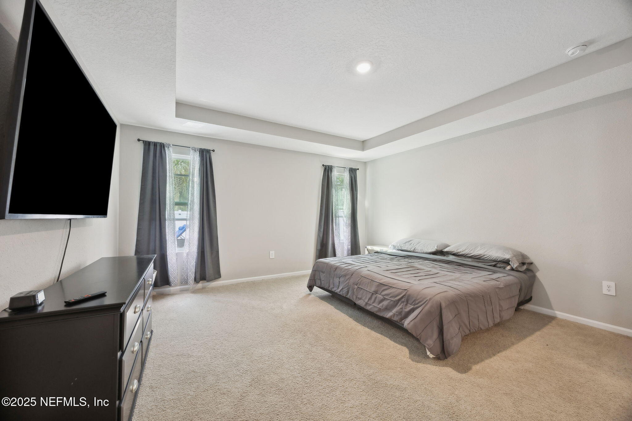 34 Riva Ridge Court Jacksonville, FL 32218 - Photo 16 of 34 a spacious bedroom with a bed and a flat screen tv