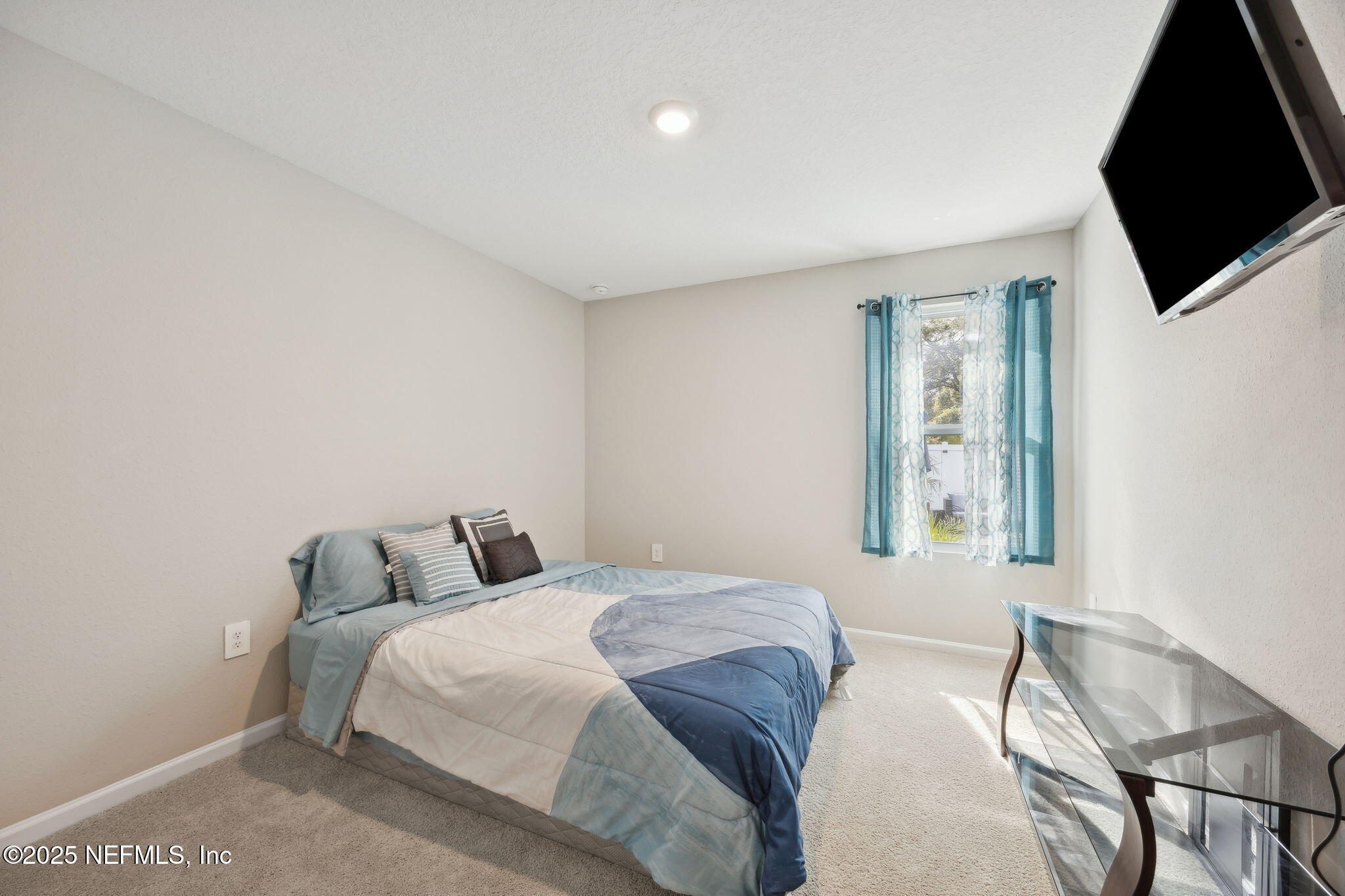 34 Riva Ridge Court Jacksonville, FL 32218 - Photo 19 of 34 a bedroom with a bed and flat screen tv