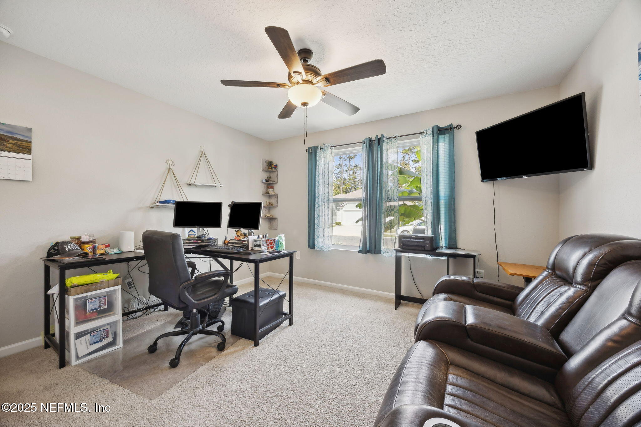 34 Riva Ridge Court Jacksonville, FL 32218 - Photo 25 of 34 a work room with furniture and a flat screen tv