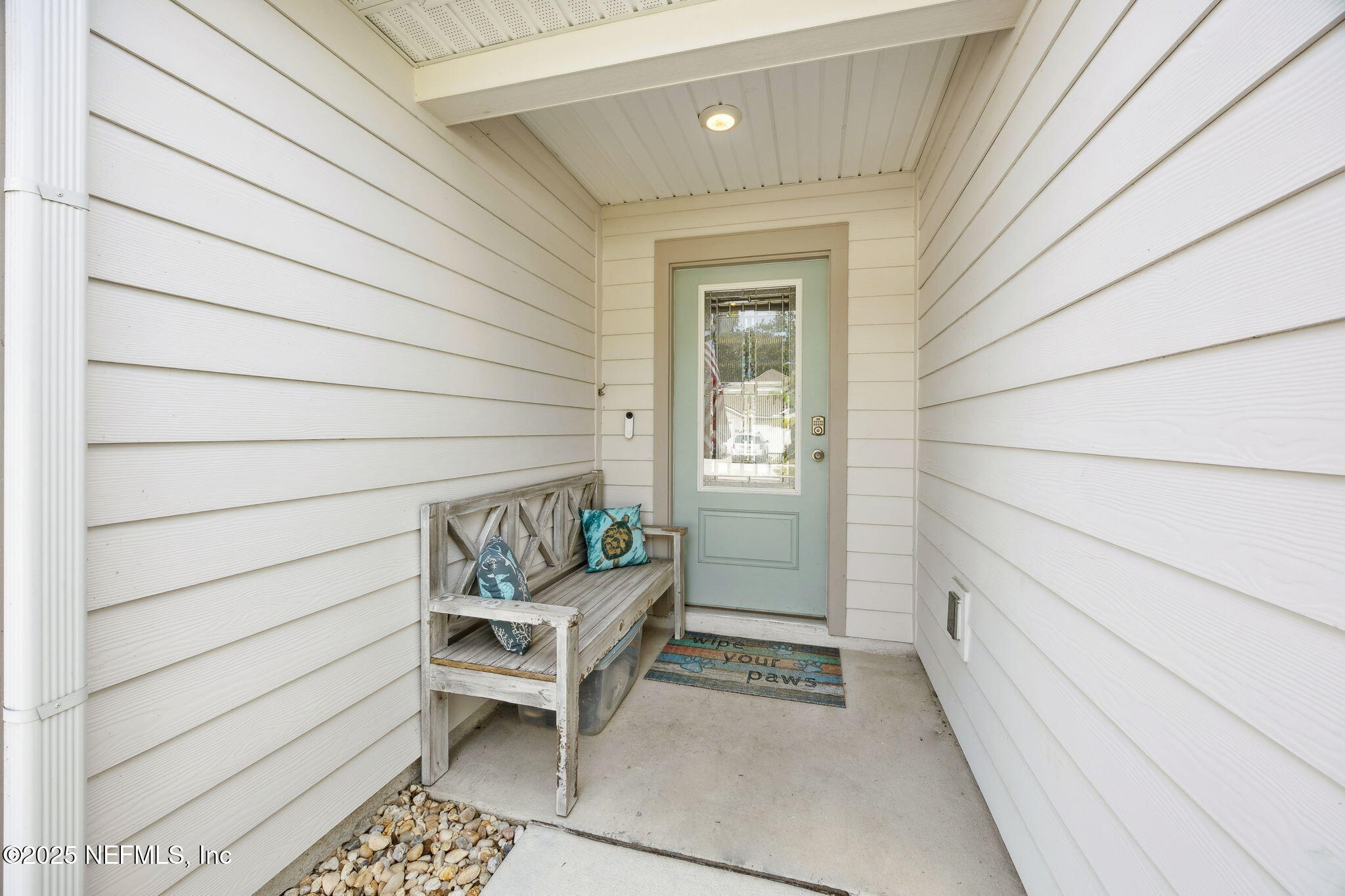 34 Riva Ridge Court Jacksonville, FL 32218 - Photo 3 of 34 a porch with a chair and potted plant on a wooden floor