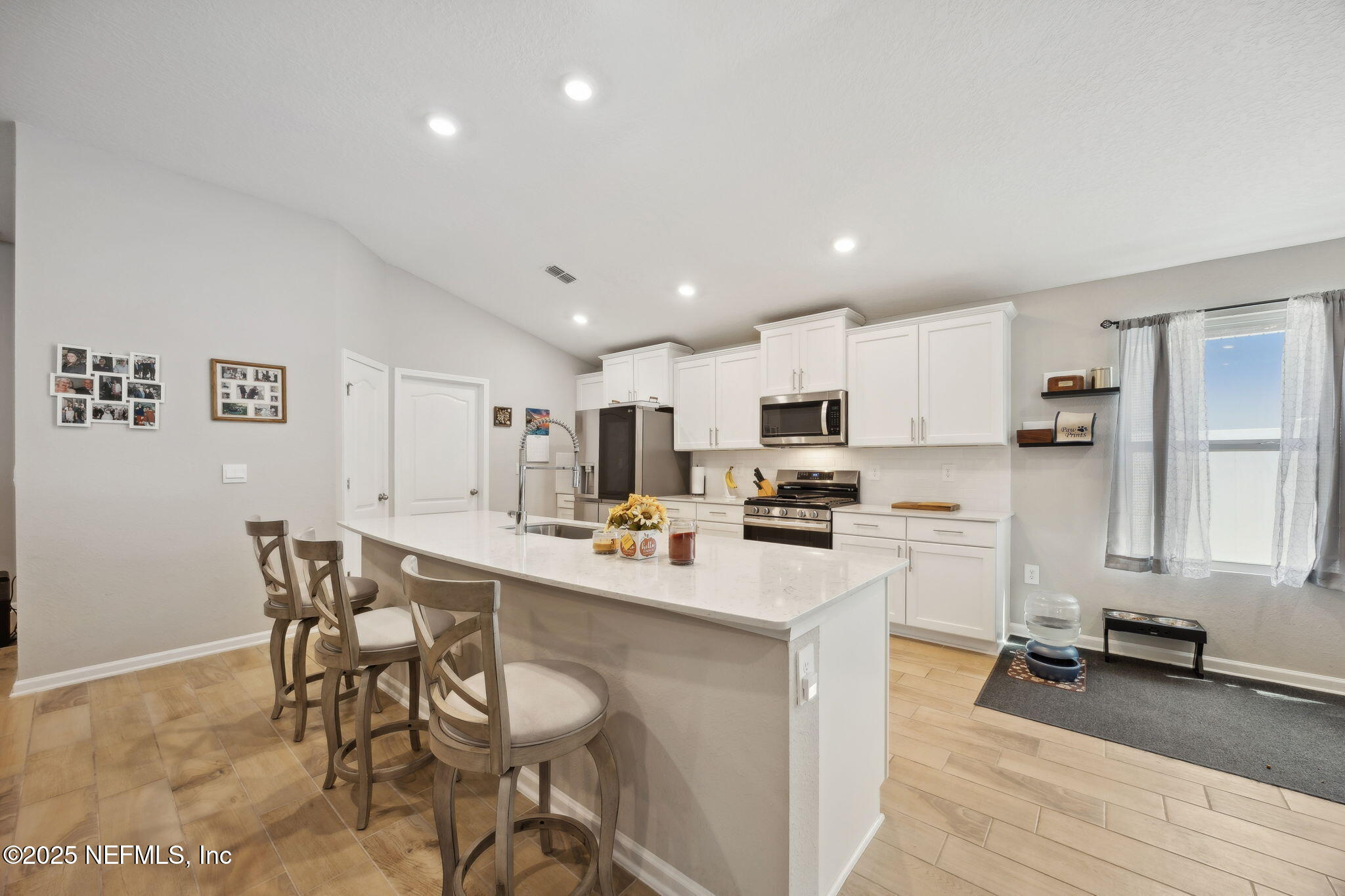 34 Riva Ridge Court Jacksonville, FL 32218 - Photo 8 of 34 a kitchen with a sink a stove a refrigerator and white cabinets