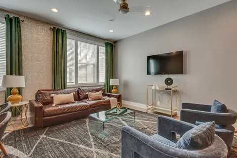 a living room with furniture and large windows