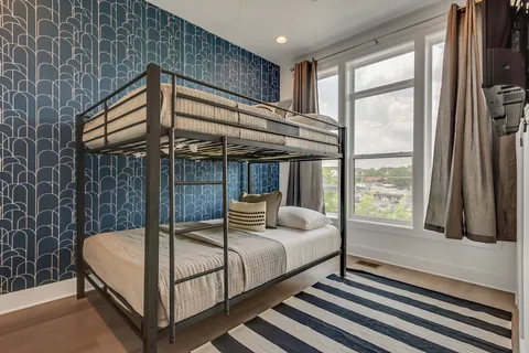 a bedroom with 2 bed and a window