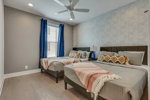 a bed sitting in a bedroom next to a lamp