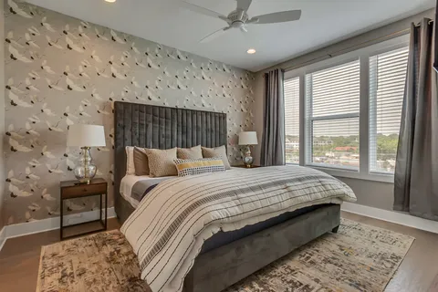 a bedroom with a large bed and a flat screen tv