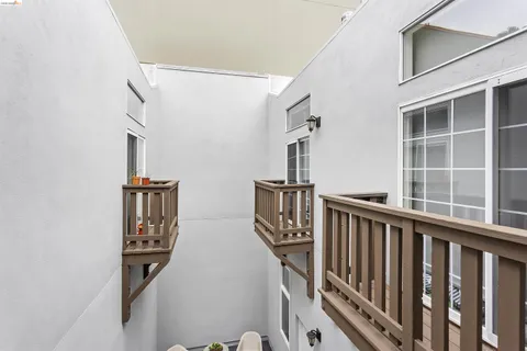 a view of staircase with railing and a window