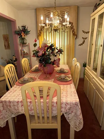 a dining room with furniture and chandelier kitchen view