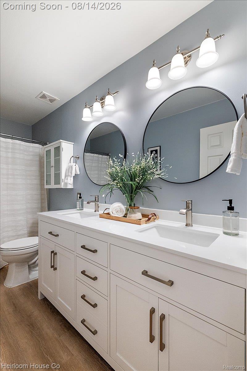 45697 Bryn Mawr Road Canton, MI 48187 - Photo 46 of 75 Spacious bathroom featuring a double vanity with ample storage, dual sinks, and two circular mirrors