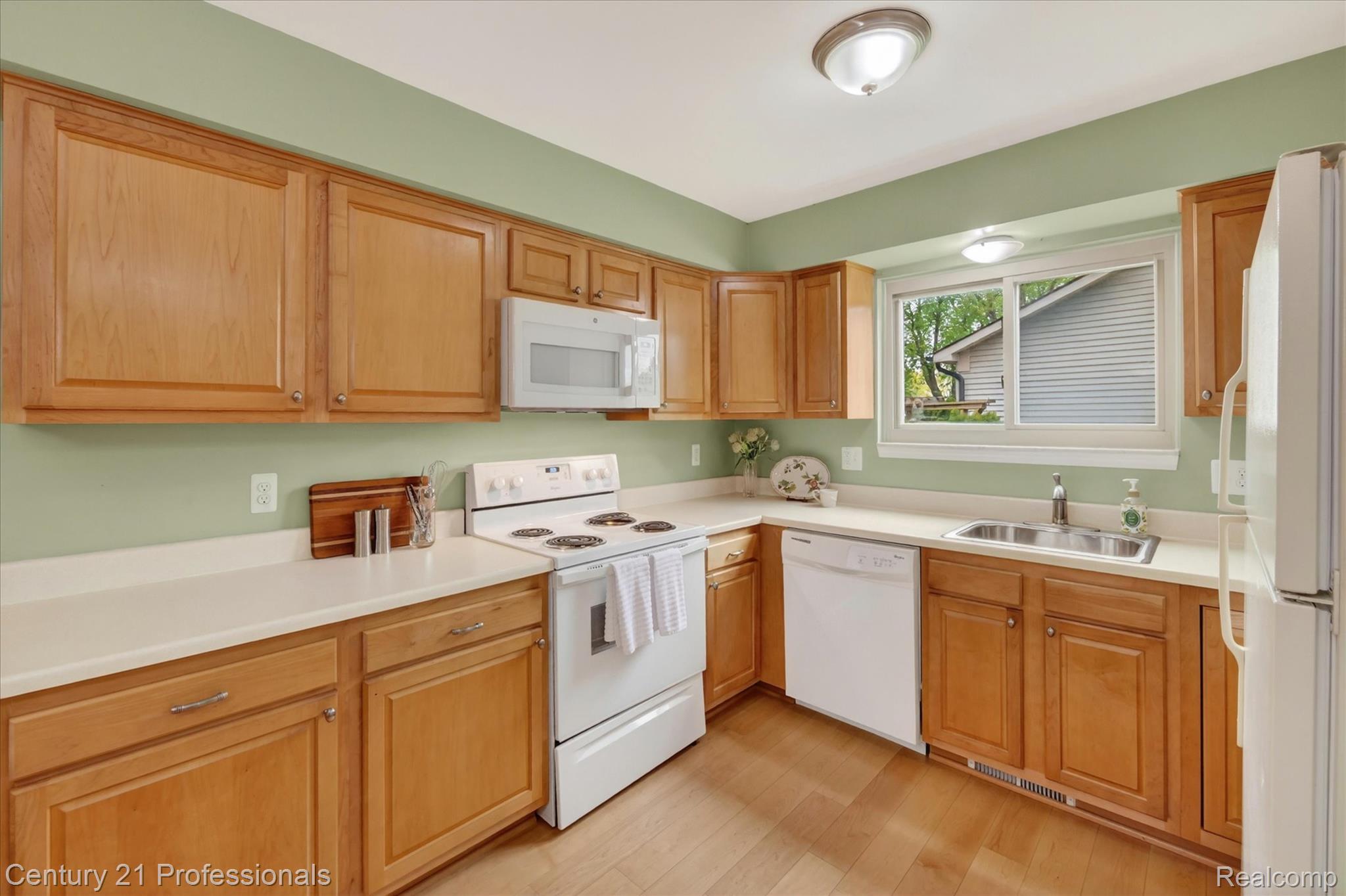 134 Foxboro Drive Rochester, MI 48309 - Photo 12 of 39 Kitchen featuring white appliances, light countertops, light wood-style flooring, and wood finish cabinetry