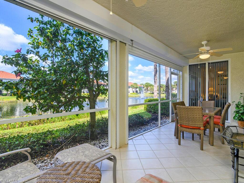23831 San Marino Road, Unit 102 Estero, FL 34135 - Photo 26 of 39 Sunroom with tile patterned floors, a textured ceiling, and a water view