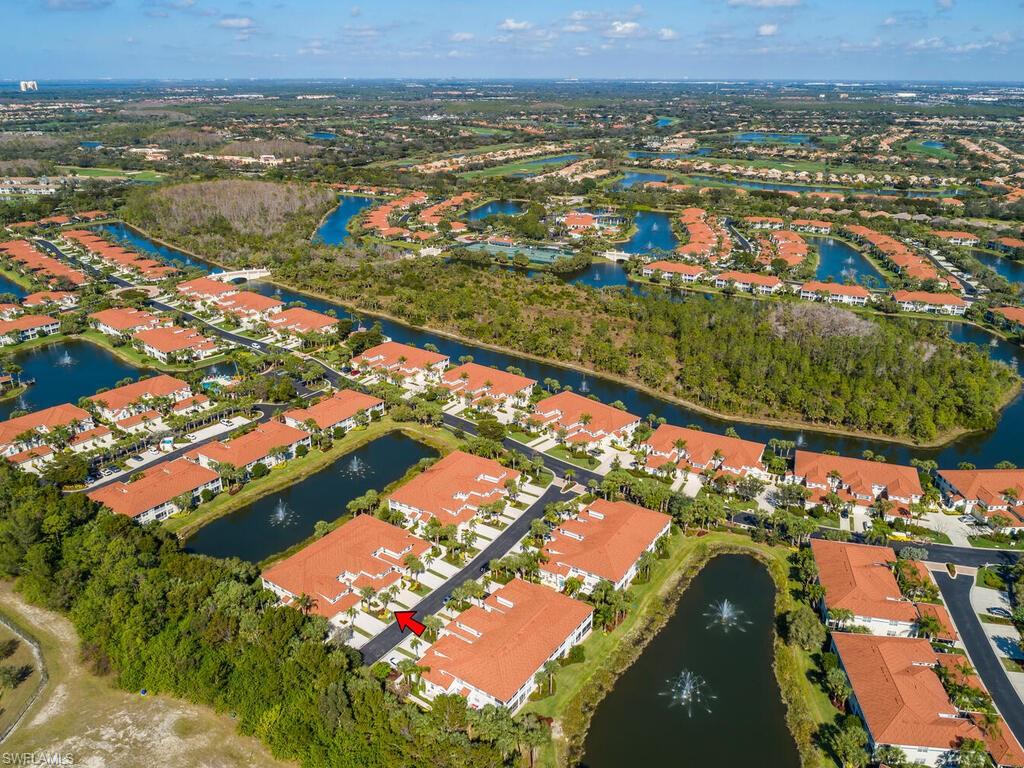 23831 San Marino Road, Unit 102 Estero, FL 34135 - Photo 30 of 39 Aerial view of property and surrounding area featuring a nearby body of water and nearby suburban area