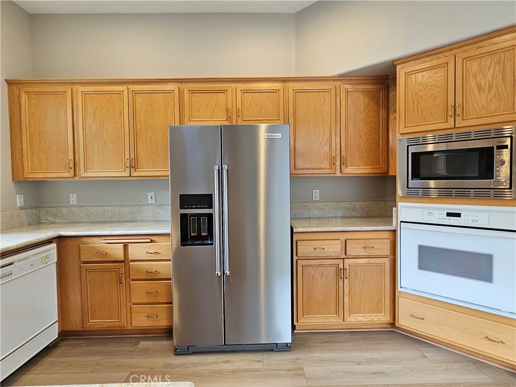 516 Morning Rise Lane Arroyo Grande, CA 93420 - Photo 6 of 16 a kitchen with granite countertop a refrigerator stove and microwave