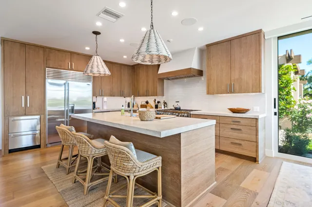 a kitchen with a table chairs stove and cabinets