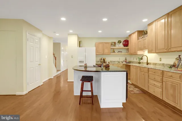 a kitchen with a sink cabinets and wooden floor