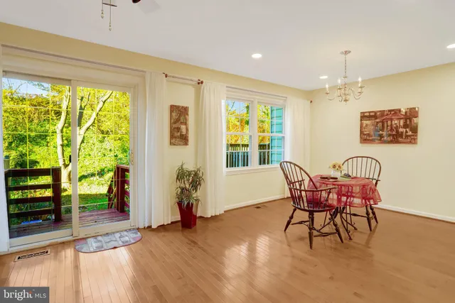a view of a dining room with furniture and windows