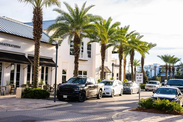 a view of multiple houses with a yard and furniture