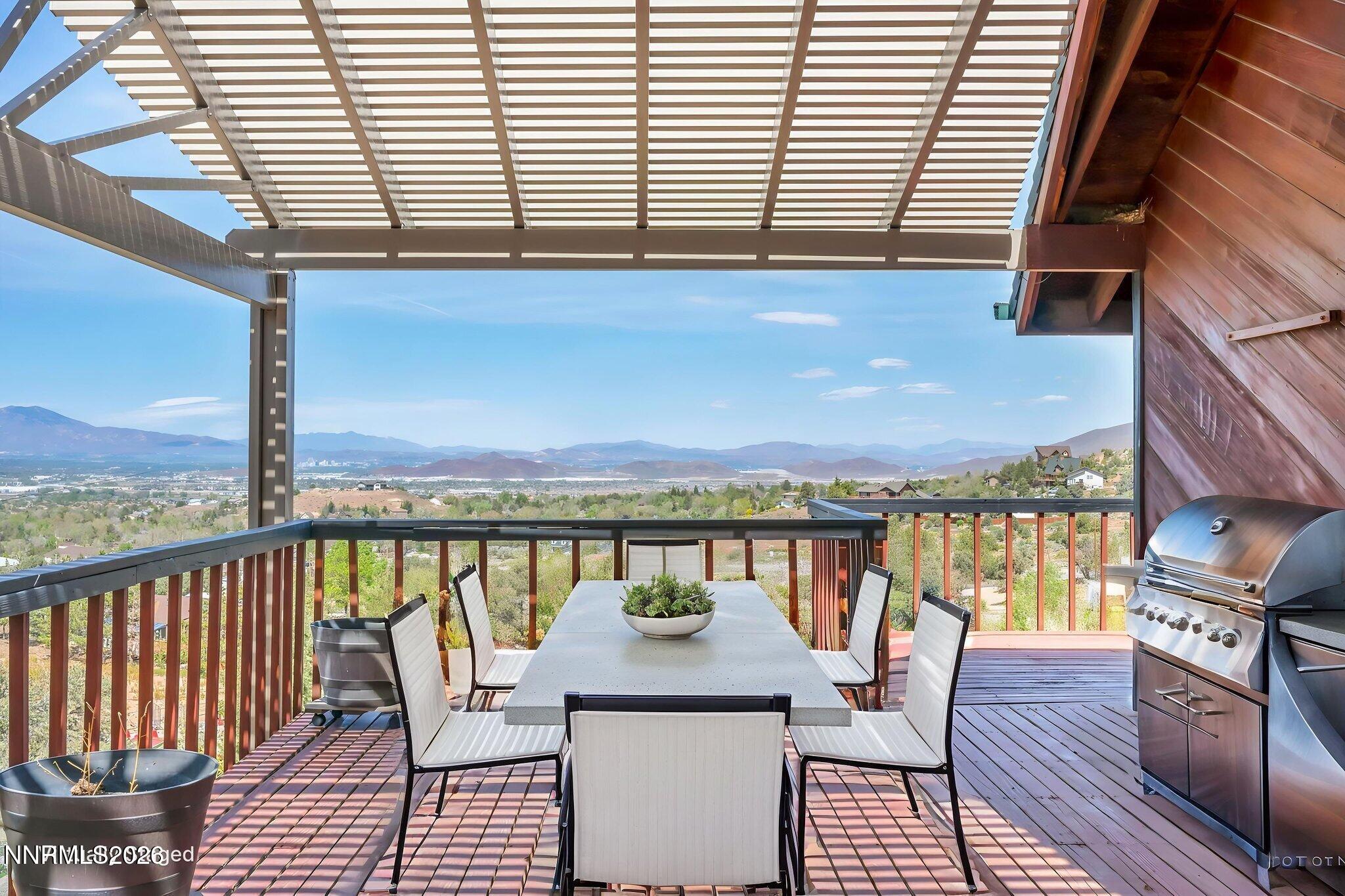 1970 Geiger Grade Road Reno, NV 89521 - Photo 8 of 45 a view of a balcony with wooden chairs and ocean view
