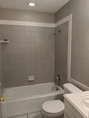 a bathroom with a toilet a sink and bathtub
