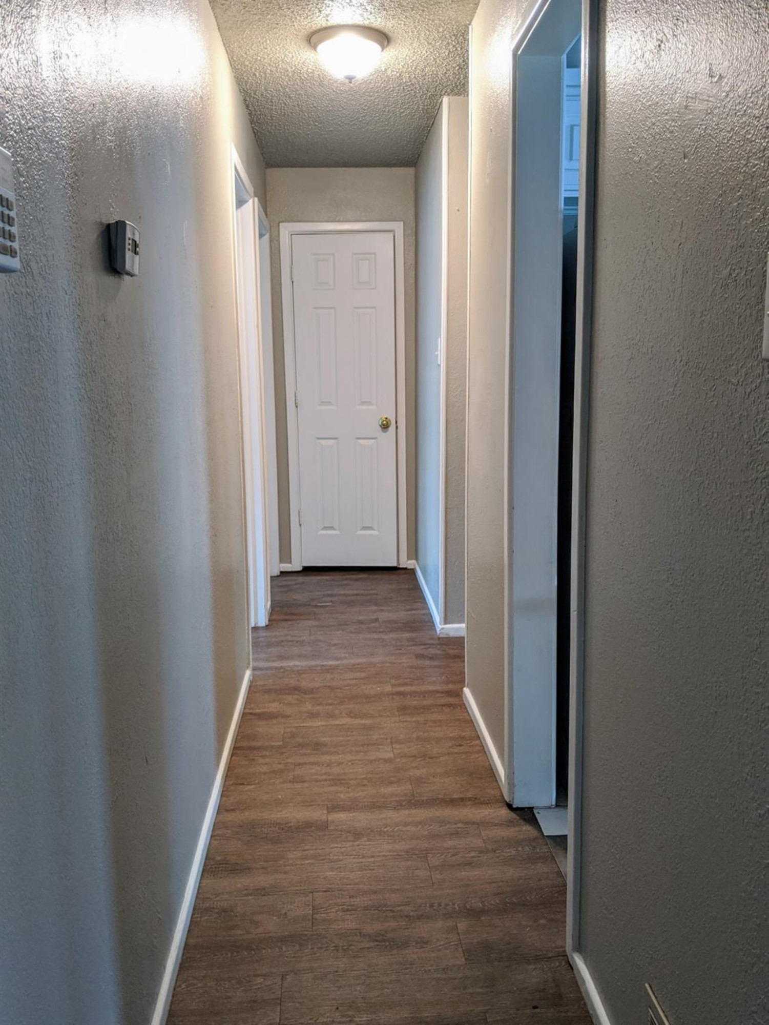 5525 Fordham Street Lubbock, TX 79416 - Photo 7 of 12 a view of a hallway with wooden floor