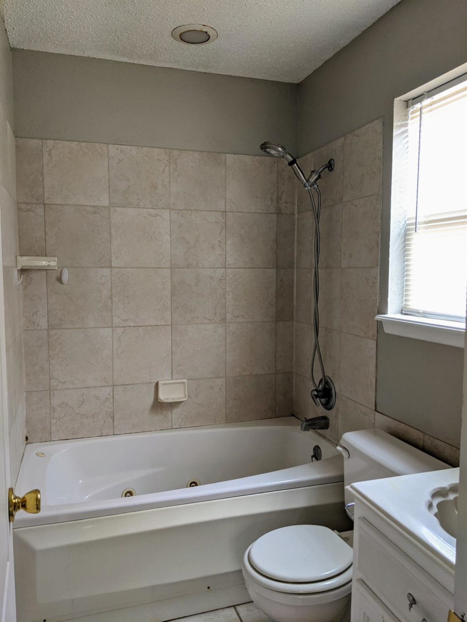 5525 Fordham Street Lubbock, TX 79416 - Photo 9 of 12 a bathroom with a bathtub shower sink vanity and toilet