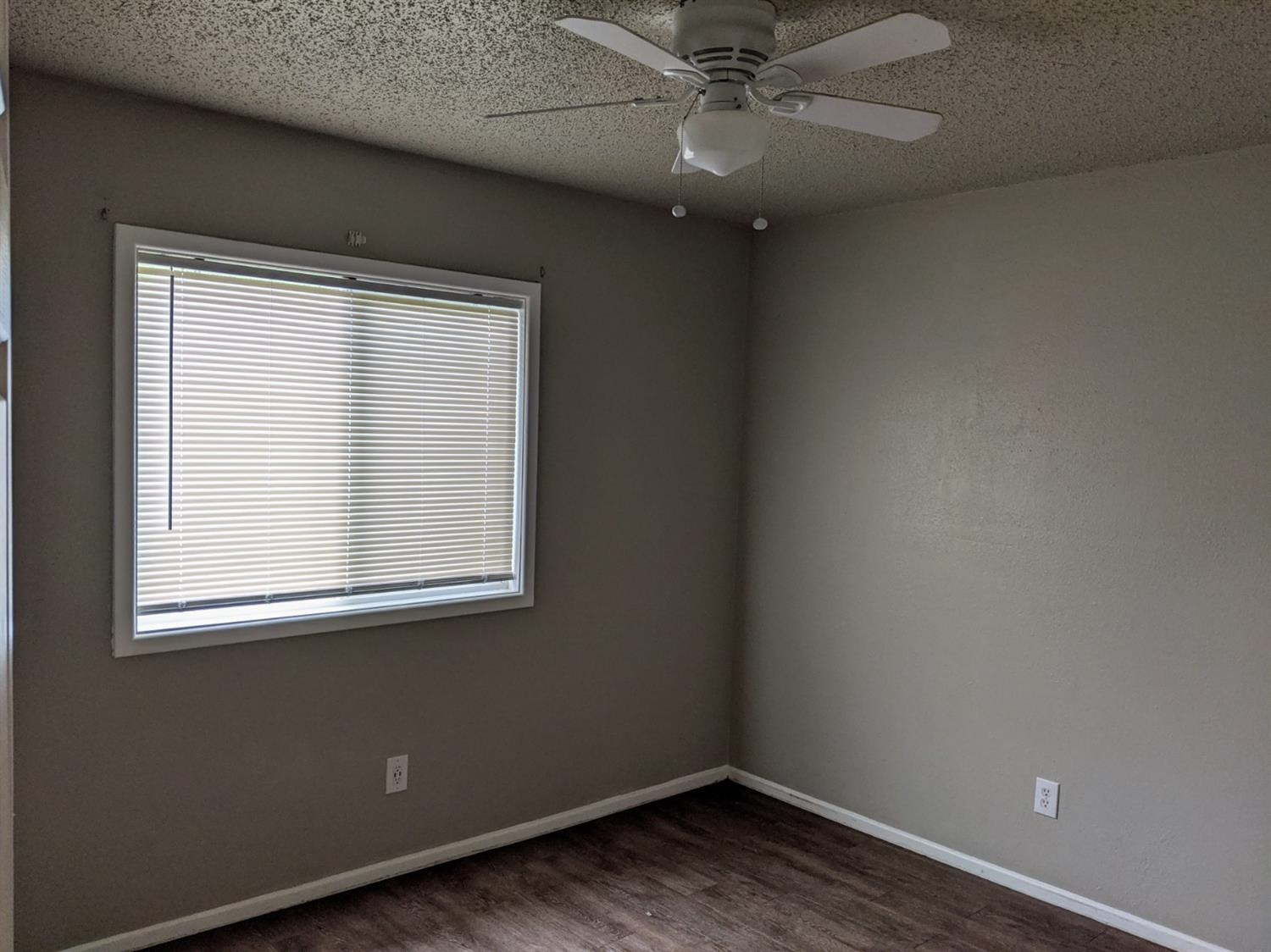 5525 Fordham Street Lubbock, TX 79416 - Photo 10 of 12 an empty room with wooden floor and windows