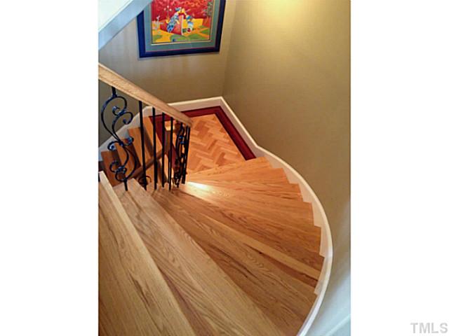1001 Salcomb Lane Raleigh, NC 27614 - Photo 14 of 25 Staircase to basement level showcases the custom hardwood flooring found throughout the main floor of this lovely home.