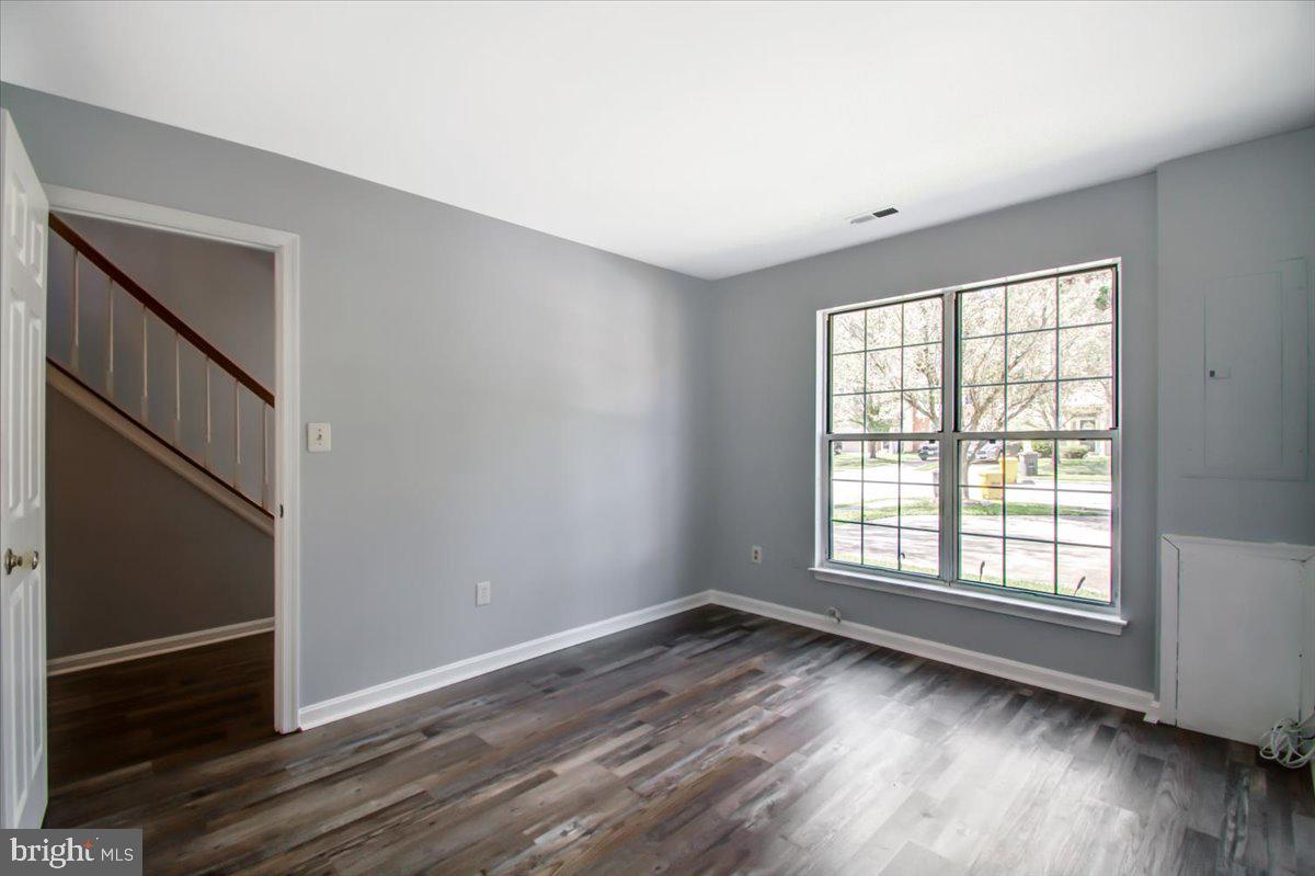 2207 Commissary Circle Odenton, MD 21113 - Photo 12 of 50 an empty room with wooden floor and windows