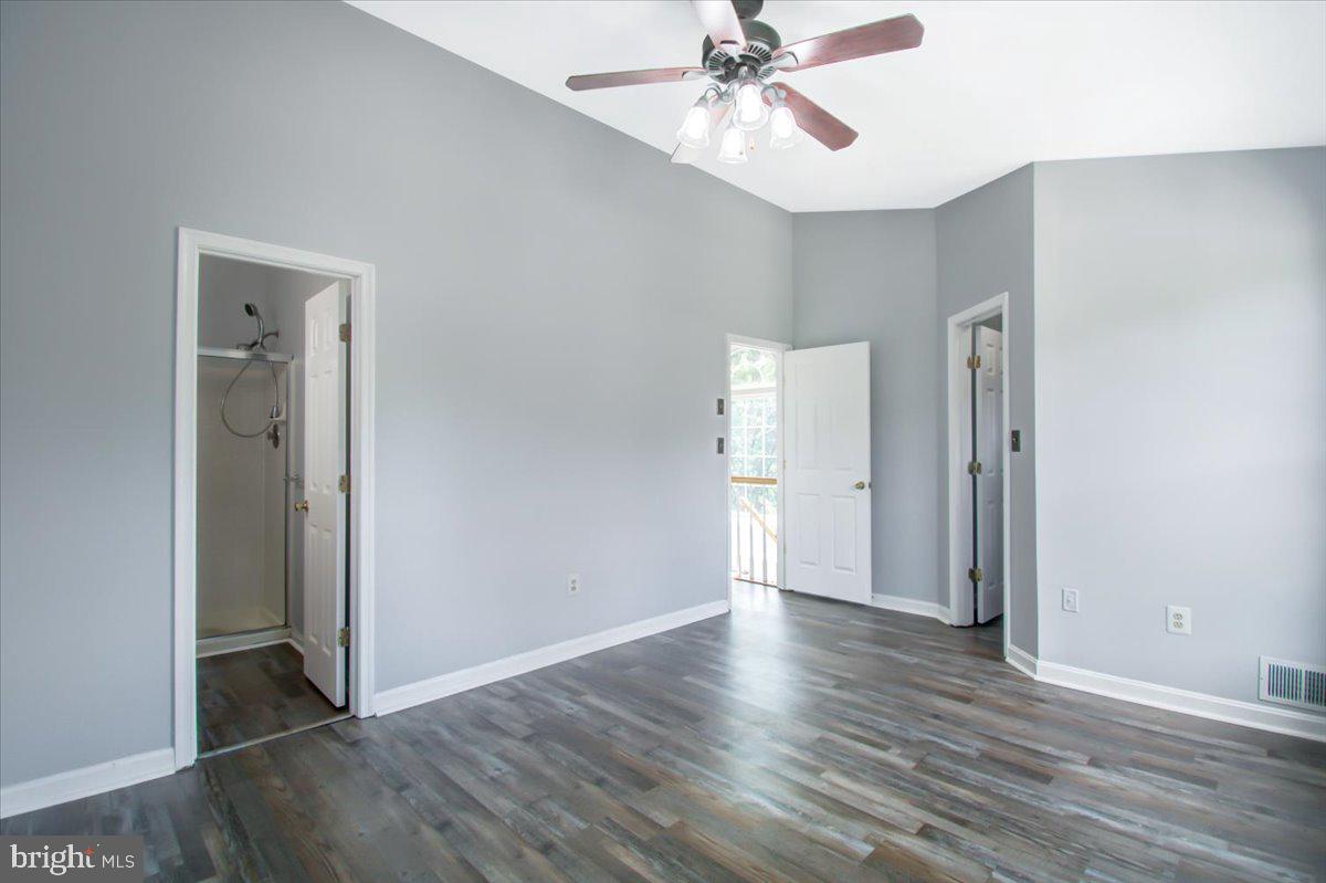2207 Commissary Circle Odenton, MD 21113 - Photo 29 of 50 an empty room with wooden floor closet and fan