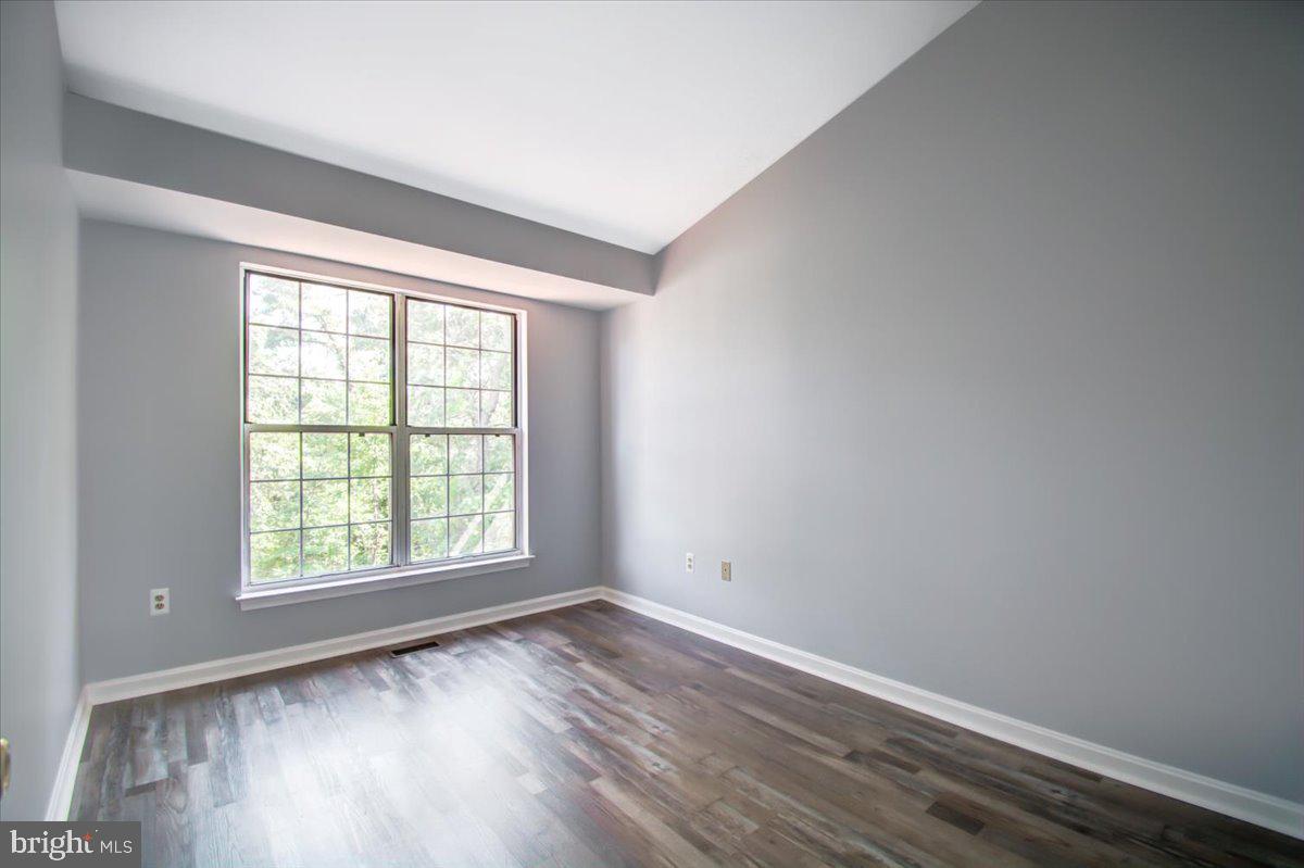 2207 Commissary Circle Odenton, MD 21113 - Photo 34 of 50 an empty room with wooden floor and windows