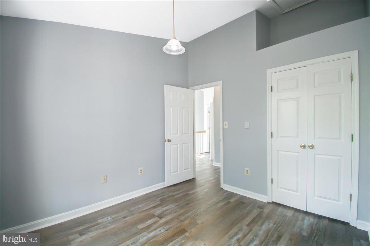 2207 Commissary Circle Odenton, MD 21113 - Photo 40 of 50 a view of an empty room with window and wooden floor