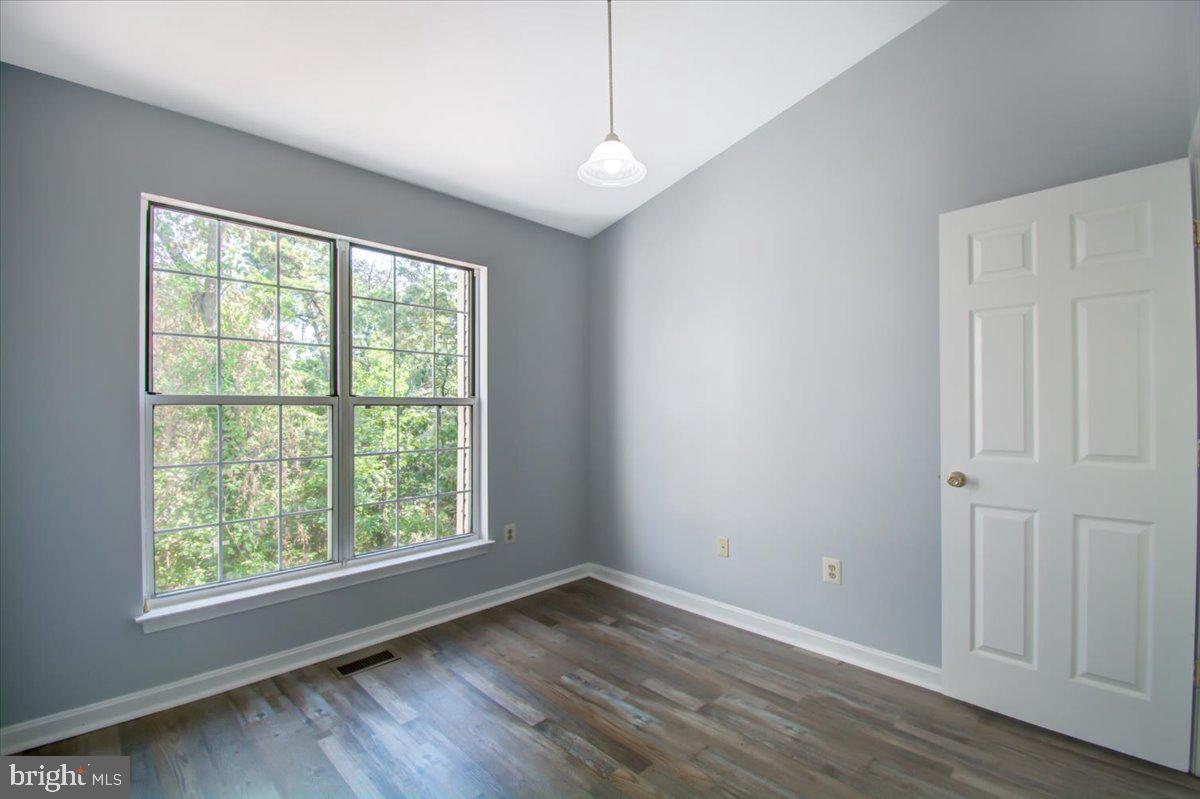 2207 Commissary Circle Odenton, MD 21113 - Photo 41 of 50 an empty room with wooden floor and windows