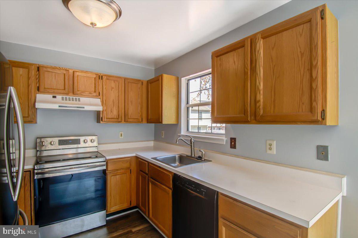 2207 Commissary Circle Odenton, MD 21113 - Photo 7 of 50 a kitchen with a sink cabinets and window