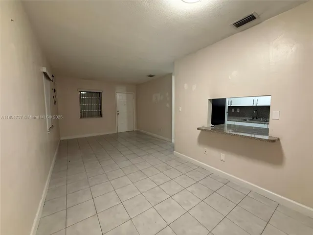 a view of an empty room and fire place