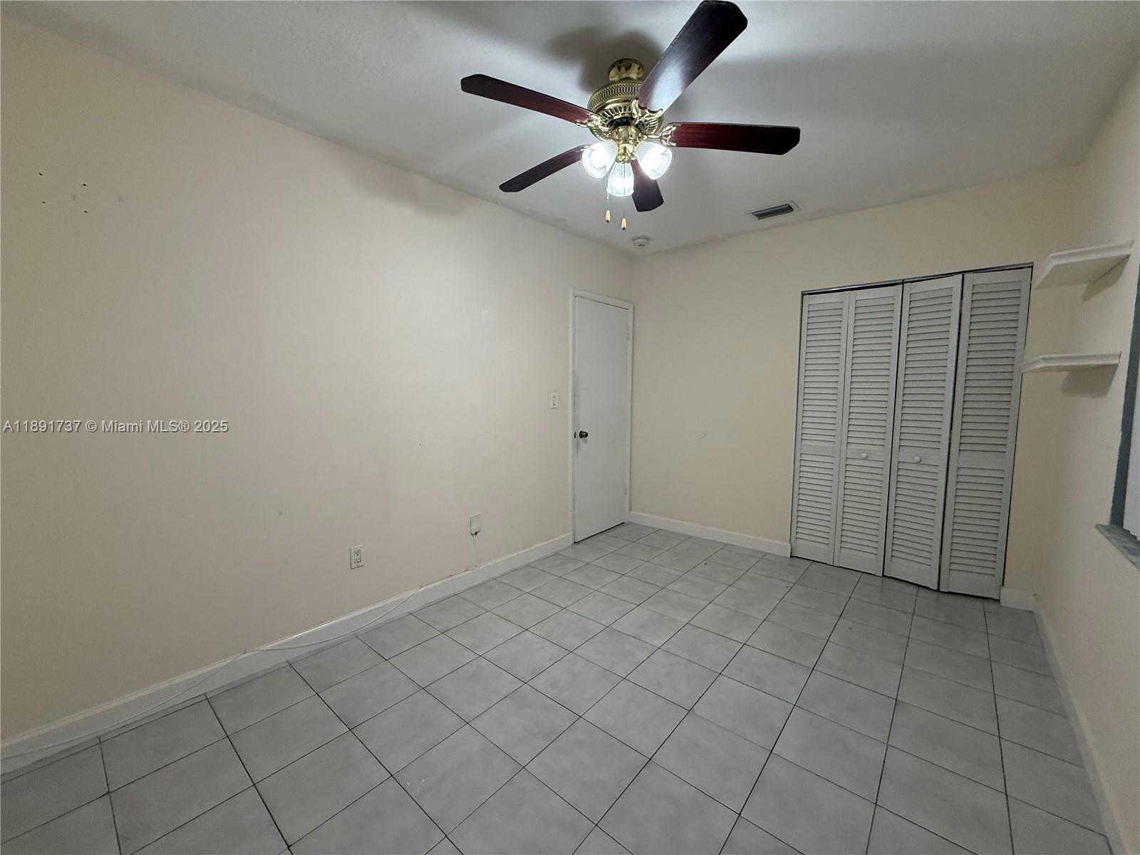 3450 Southwest 75th Court Miami, FL 33155 - Photo 15 of 22 an empty room with chandelier fan